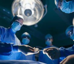 A Image of surgeons around an operating table.
