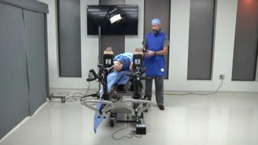An image displaying Dr. Joseph Schwab positioning his patient for an anterior approach procedure.
