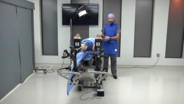 An image displaying Dr. Joseph Schwab positioning his patient for an anterior approach procedure.
