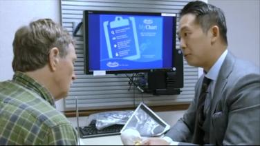 two health care professionals discussing by a PC from Posterior Cervical Laminectomy Procedure Workflow with Victor Chang, MD