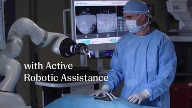 man HCP standing next to the VELYS robot from "VELYS™ Spine Hype Video"